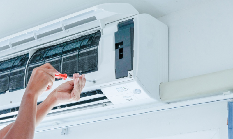 technician repairing an air conditioner