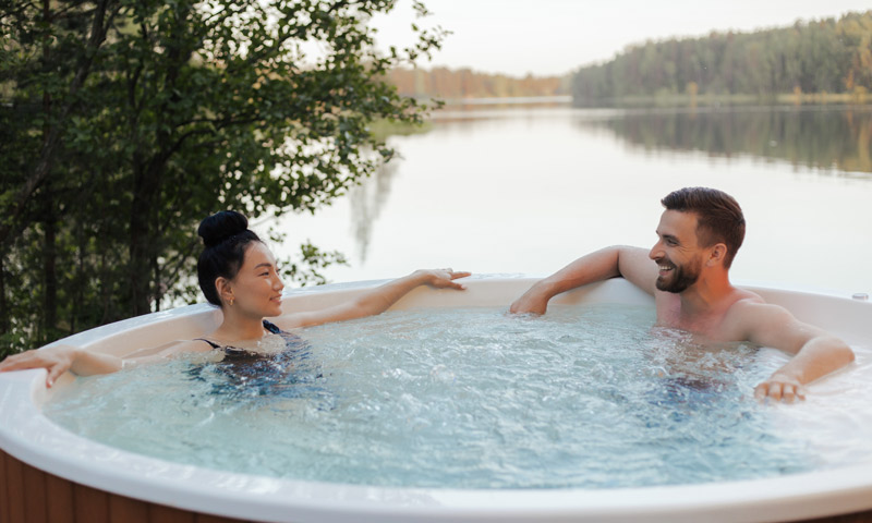 couple in hot tub looking at each other